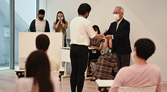 EVP Mizumoto (standing on right) appointing Student Ambassador